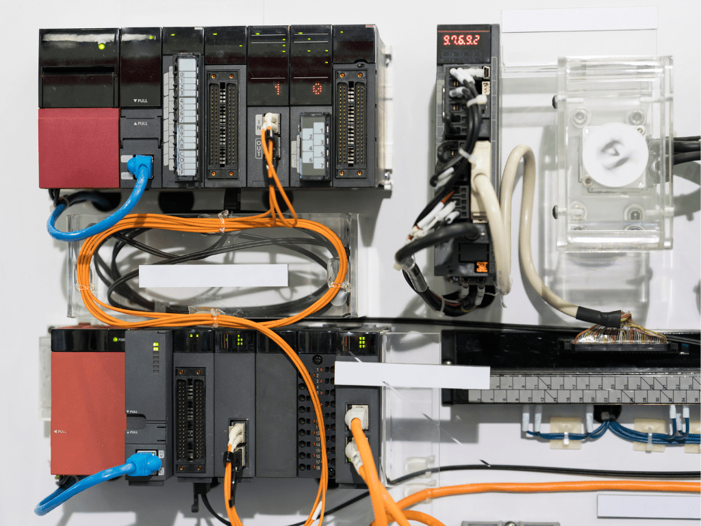 A photo of a programmable logic controller (PLC) with wires and cables attached, used for industrial automation and control.